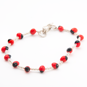 A vibrant Huayruro Silver bracelet with silver accents.