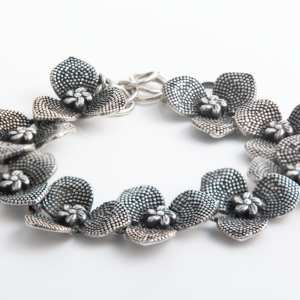 Handcrafted sterling silver orchid flower bracelet with intricate detailing